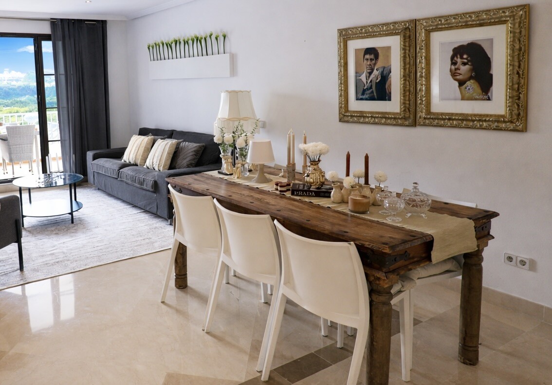 Property styling with timber dining table, artwork and decoration